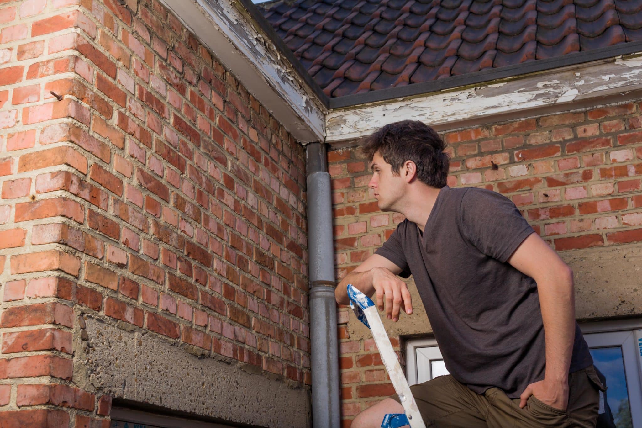 man on a ladder to Inspect Your Roof