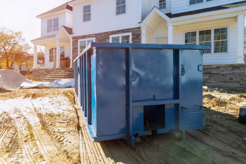 blue dumpster in front of home