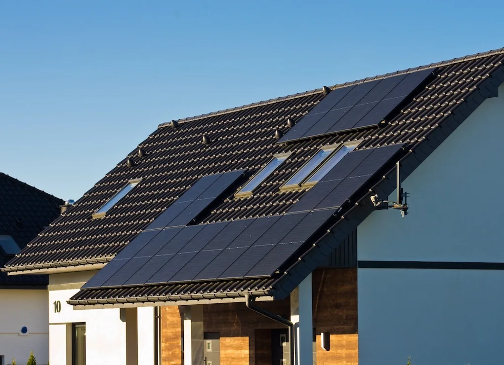 house roof with black solar panels