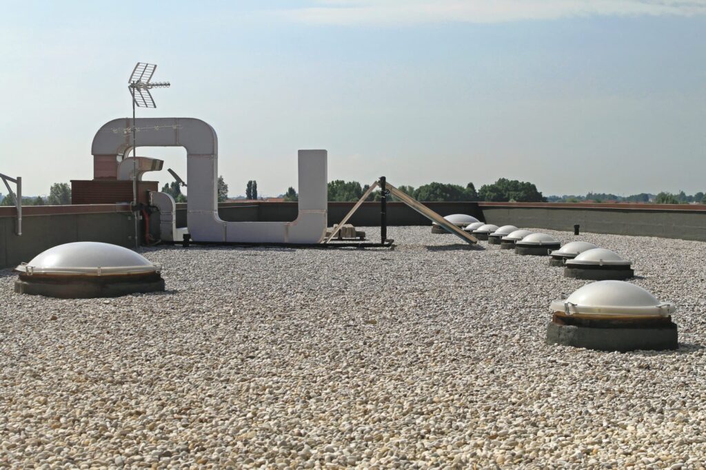 built up roof with rocks on commercial roof