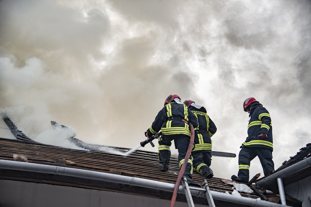 firefighters on shingle roof 