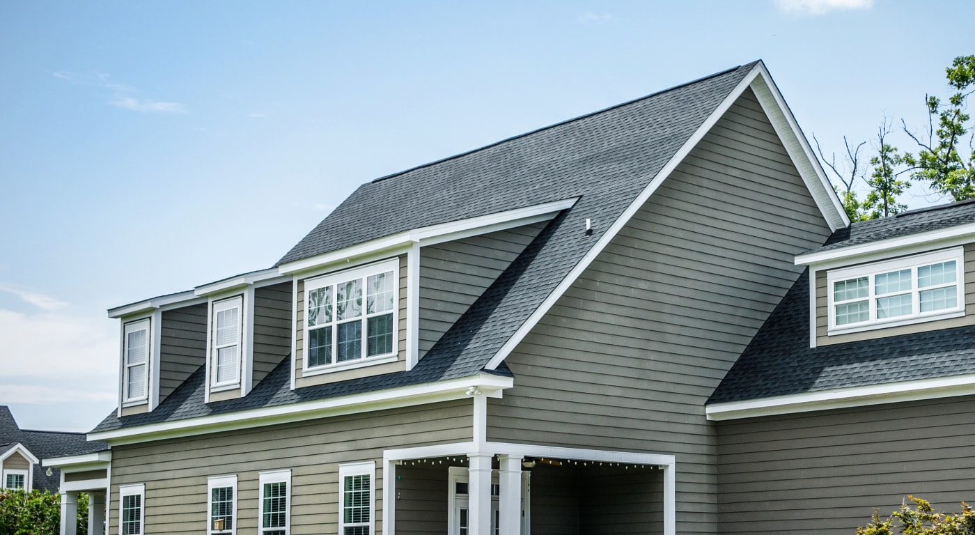 shingle roofing on green siding home