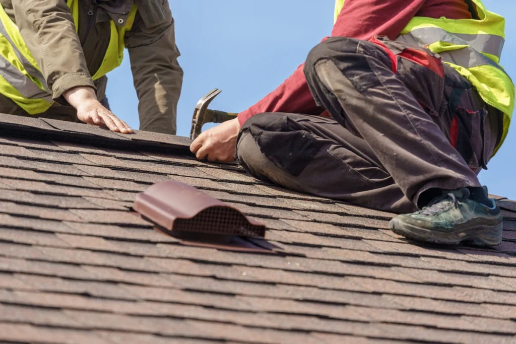 two roofer working on asphalt shingles
