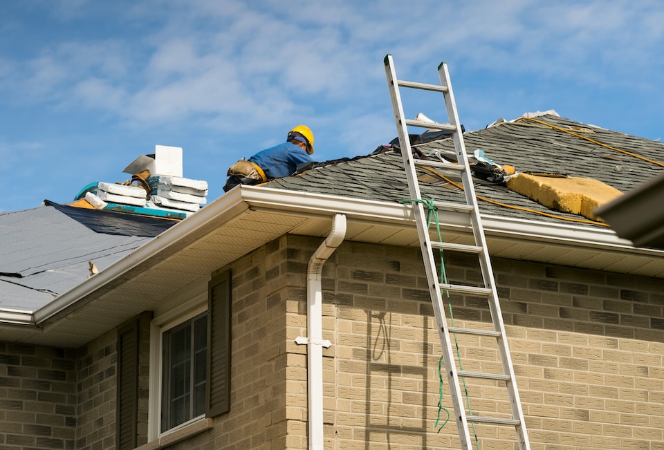 roofers working on an asphalt shingle roof