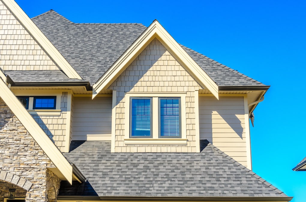 corner of home with shingle roof and siding