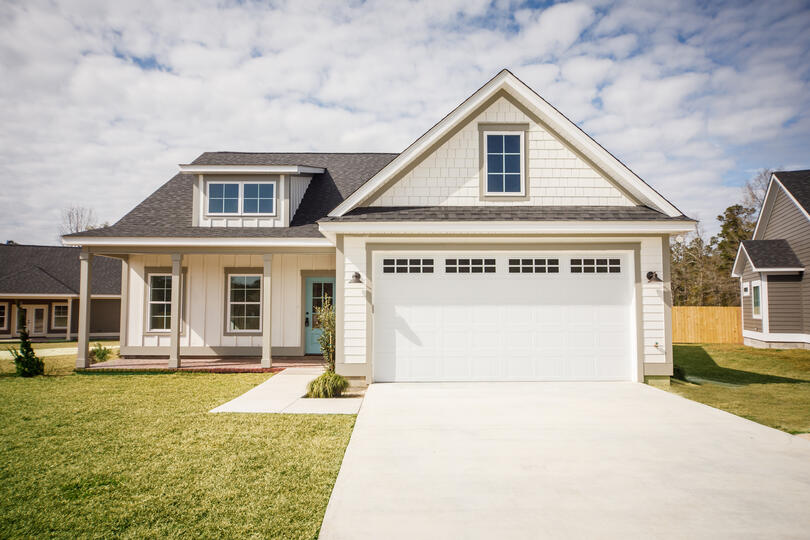 roofing lady lake-white sided house with gray shingled roof