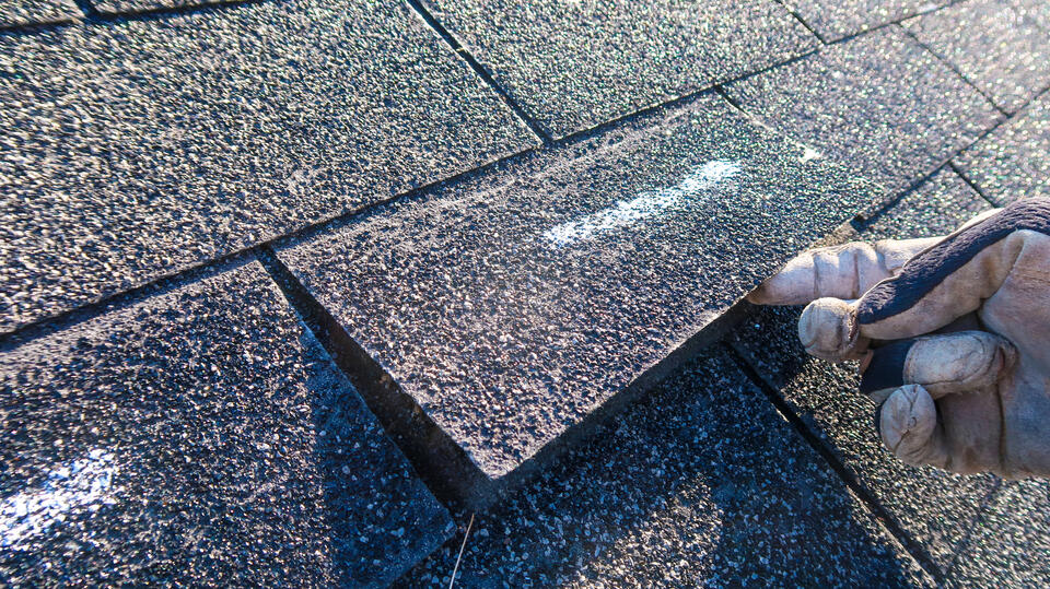 storm damage roof inspection-lifted shingles marked on a roo