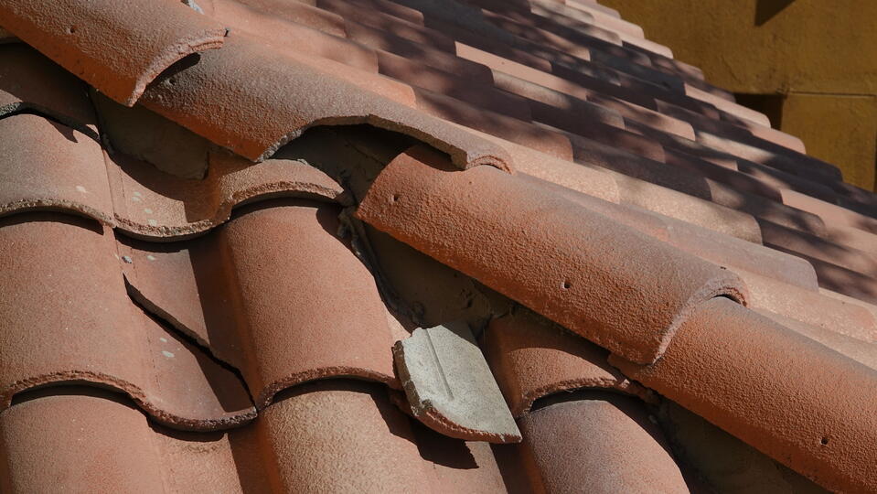tile roof repair-close up of damaged tile roofing materials